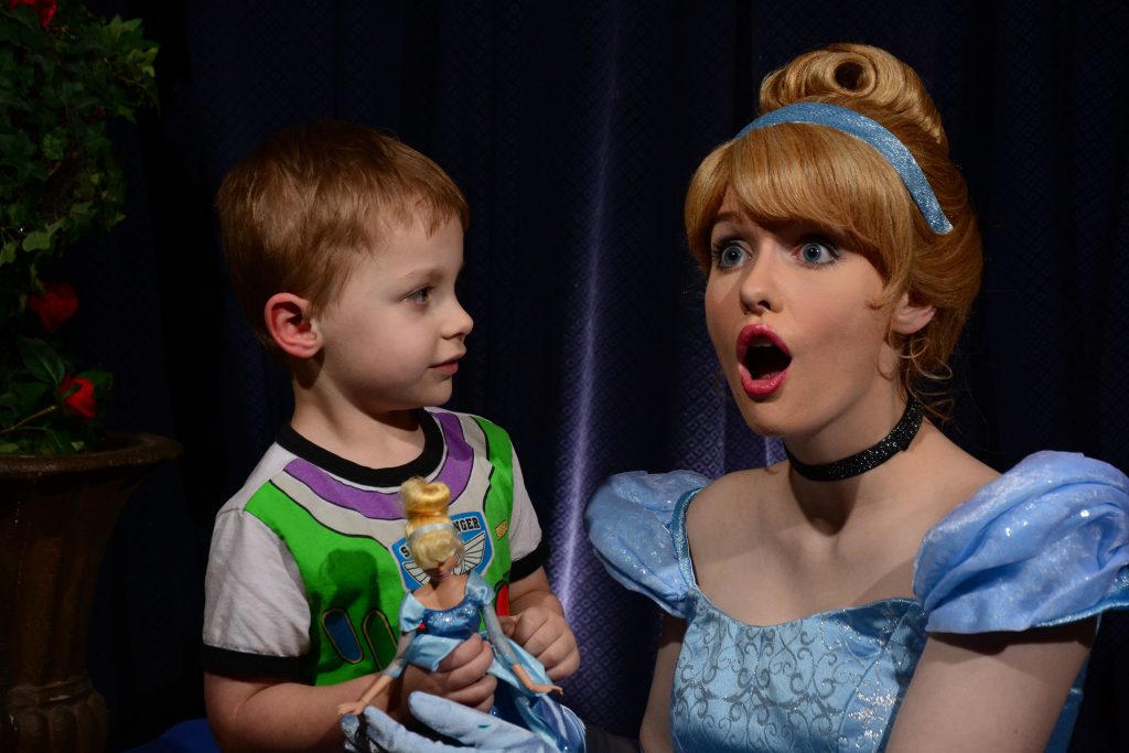 Cinderella with surprised face with my son holding his Cinderella doll.